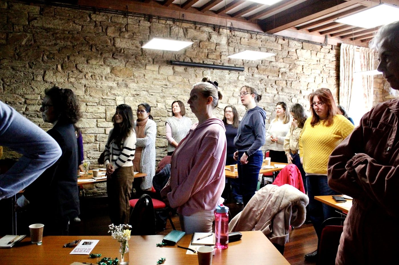 Attendees standing during the Self Mastery Network event