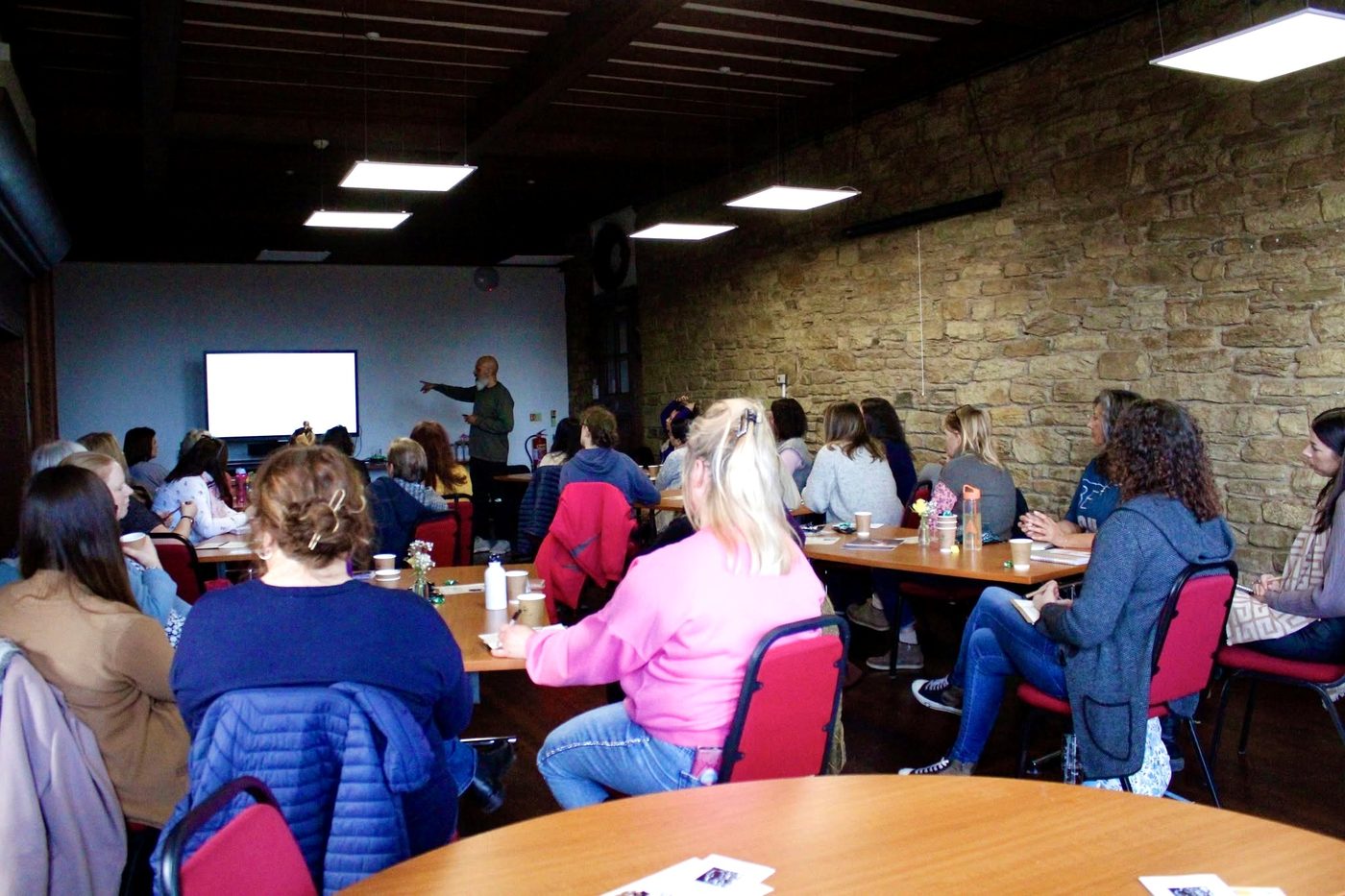 Mubeen Azam seated, speaking at the Self Mastery Network event