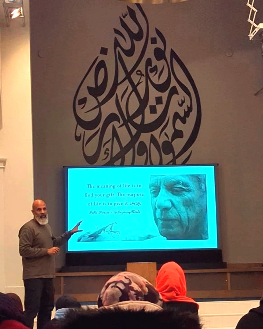 Mubeen Azam presenting a slide during a Time for Change session in Birmingham